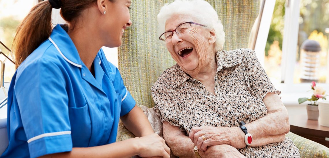 Senior,Woman,Sitting,In,Chair,And,Talking,With,Nurse,In